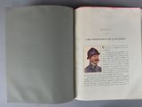 an open book with a picture of a man wearing a hat