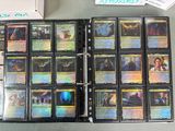 a lot of cards that are in a binder