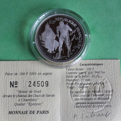 a silver coin with a picture of a soldier on it