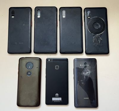 several different cell phones are lined up on a table