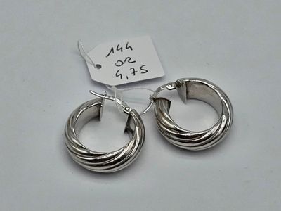 pair of silver hoop earrings on white background with price tag