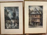 two framed pictures of a building on a table