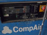 a blue machine with a sign on it that says compair