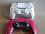 two video game controllers sitting next to each other on a table