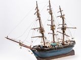 a small model of a ship on a white surface