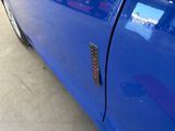 a close up of a blue car with a door handle