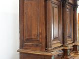 a large wooden cabinet in the corner of a room