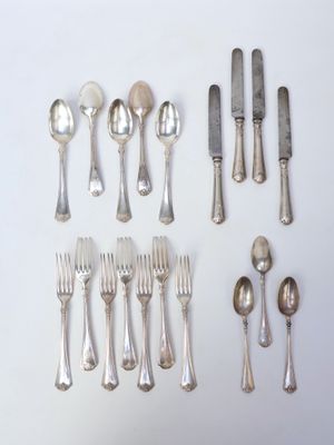 a lot of silver spoons and spoons on the table