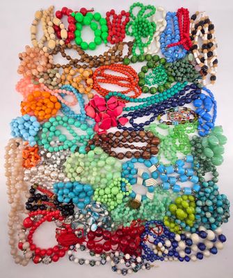 assorted beaded necklaces and bracelets on a white surface
