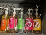 bottles of hand soaps are lined up on a shelf in a microwave