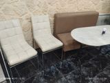 three chairs and a table in the corner of a room