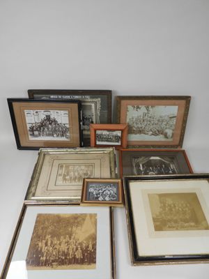 several framed photographs of people and animals are displayed on a table