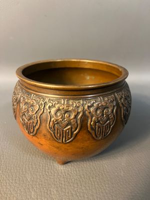 a gold bowl with a design on it