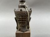 an image of a statue of a head on a wooden block