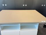 a white desk with two drawers and a shelf on top of it