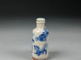 a small blue and white vase sitting on a table