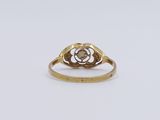 an image of a gold ring with a flower in the middle
