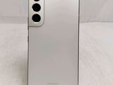 a close up of the back of a white phone on a table