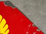 a shell logo on the side of a red and yellow sign
