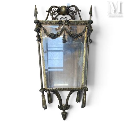 a mirror hanging on the wall with an ornate design