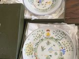 two plates and a bowl in a box on a table