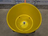a large yellow bowl sitting on the ground next to a sign