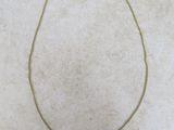 a gold necklace with a coin on it