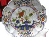 a plate with a flower design on it sitting on a table