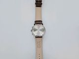 a watch that is laying on a white surface