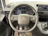the interior of a car with a steering wheel and dashboard controls