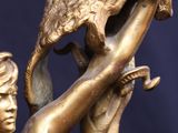 bronze statue of a woman holding a bird in her hand