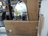 a mirror sitting on top of a box in the middle of a room