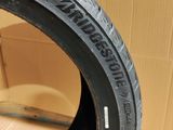 a close up of a tire on a cardboard box with a cardboard box in the background