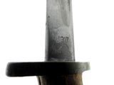 a close up of a knife on a wooden table