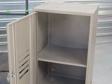 a metal cabinet with a door open and a hand truck next to it