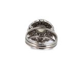 an image of a white gold ring with a white topaz stone surrounded by diamonds