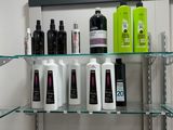 many bottles of hair products on the shelves in the store