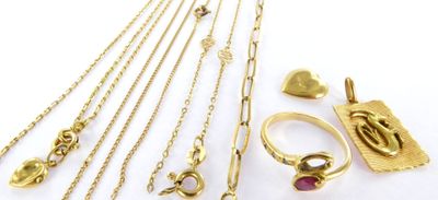 a close up of a bunch of gold jewelry on a white surface