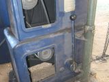 a blue oven that is sitting in the dirt