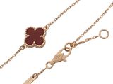 an image of a gold chain with a red stone in the middle