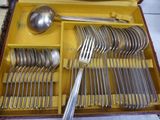 a yellow box with silverware in it on a table