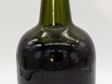 a black bottle with a gold cap on a white background