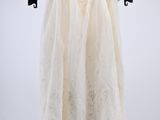 an image of a white dress hanging on a black hanger