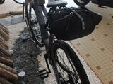 a bike that is parked next to a pile of logs