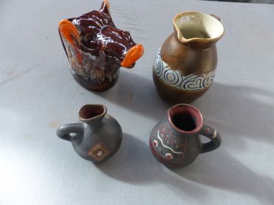 three small vases sitting on a table next to each other