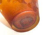 a glass vase with a design on it sitting on a table