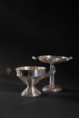 a pair of silverplated bowls and spoons on a black background