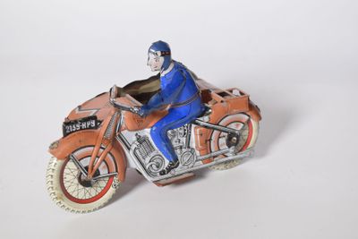 a figurine of a man riding a motorcycle on a white surface