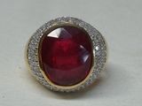 an image of a ring with a red stone surrounded by white diamonds