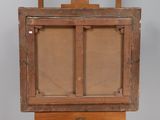 an old wooden easel with a painting on top of it